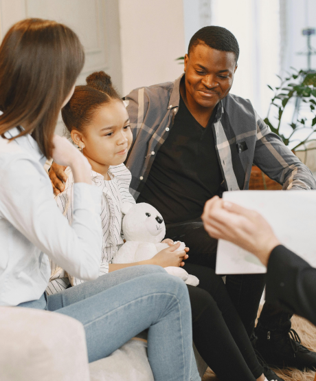 Family sitting on a couch while in a family therapy session Family sitting on a couch while in a family therapy session