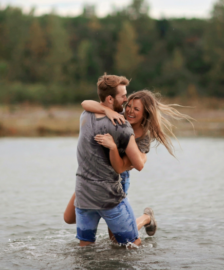Happy couple playing together in shallow water